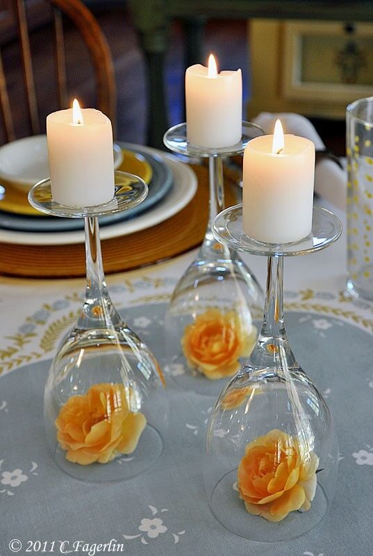 Upside down wine glasses used as candle holders for wedding centerpiece